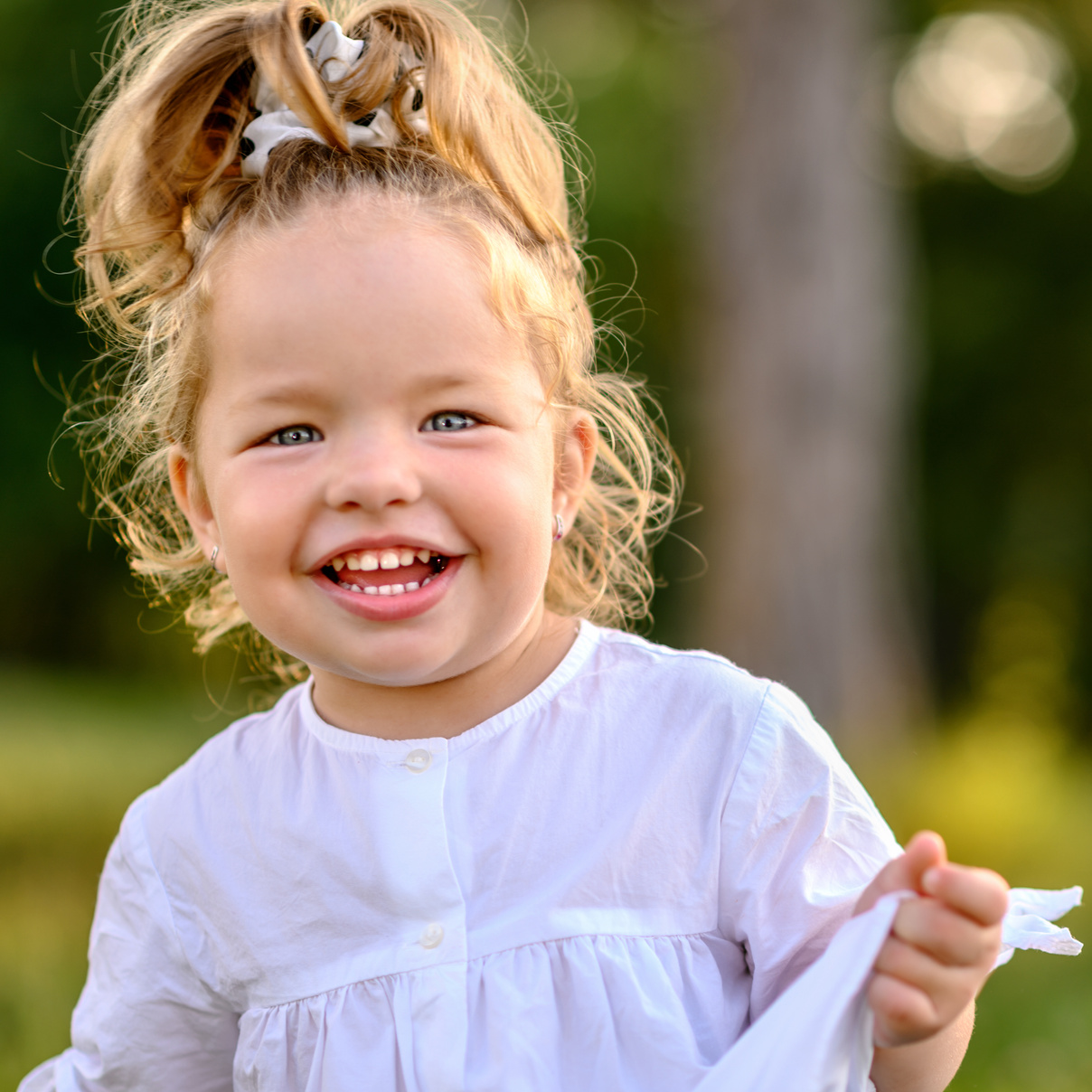 Happy toddler girl smiling outside